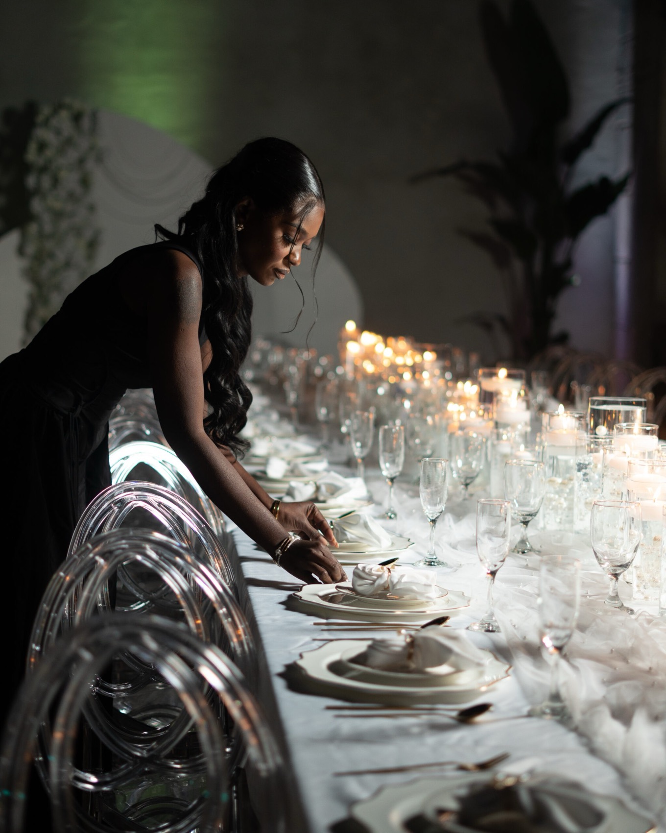 Cleodine Pierre, founder of VaLuxe, setting a candlelit reception table
