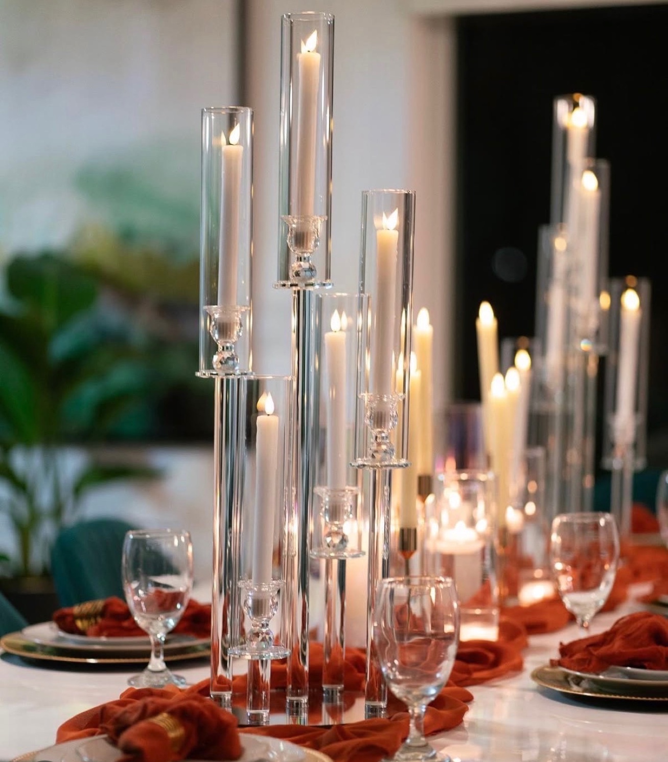 Crystal candelabras with taper candles, rust napkins and gold chargers